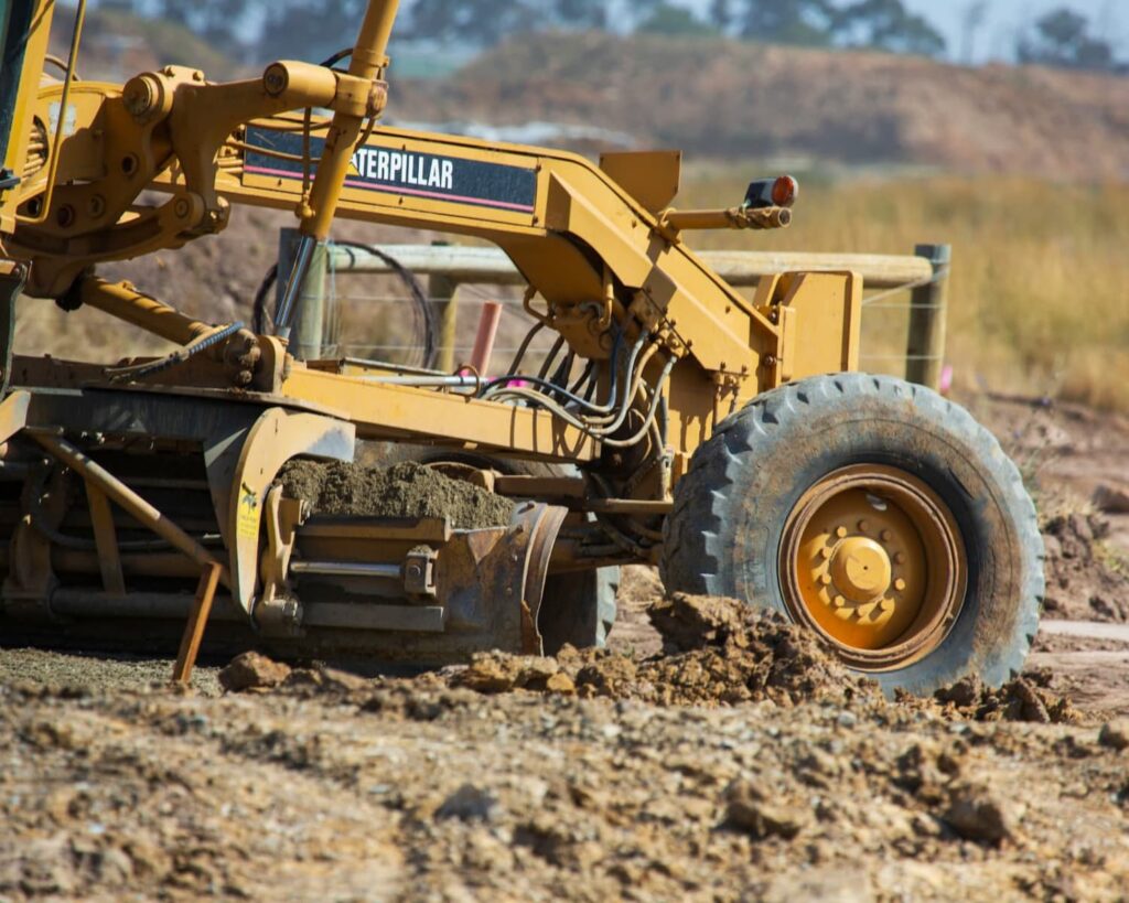 A grader heavy vehicle working in a residential site.