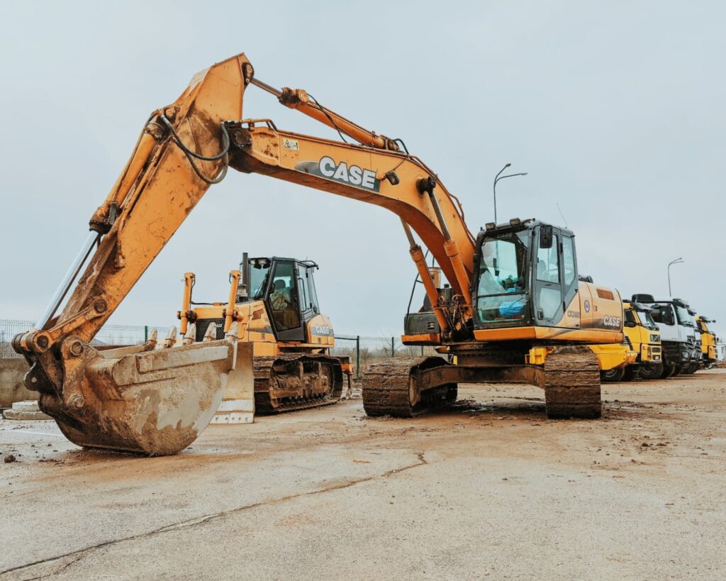 A group of excavators parked in a site.